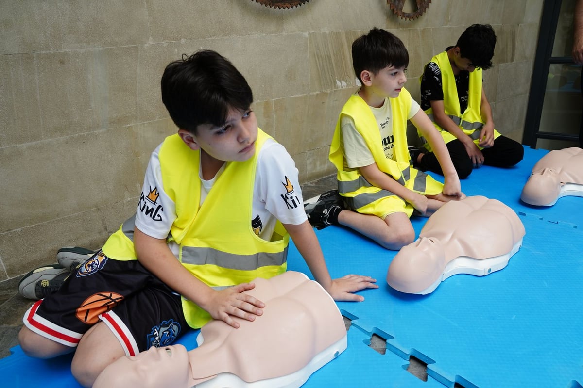 Young people practicing CPR and emergency response skills