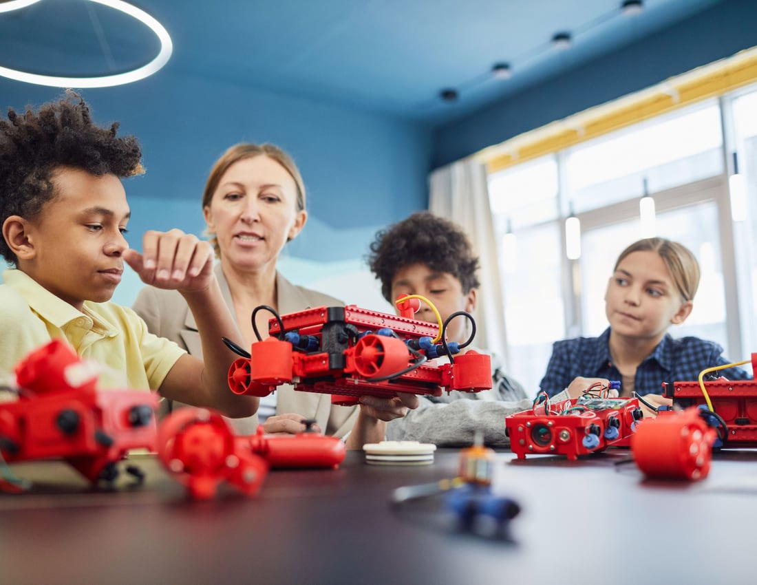Young people building robots with an educator